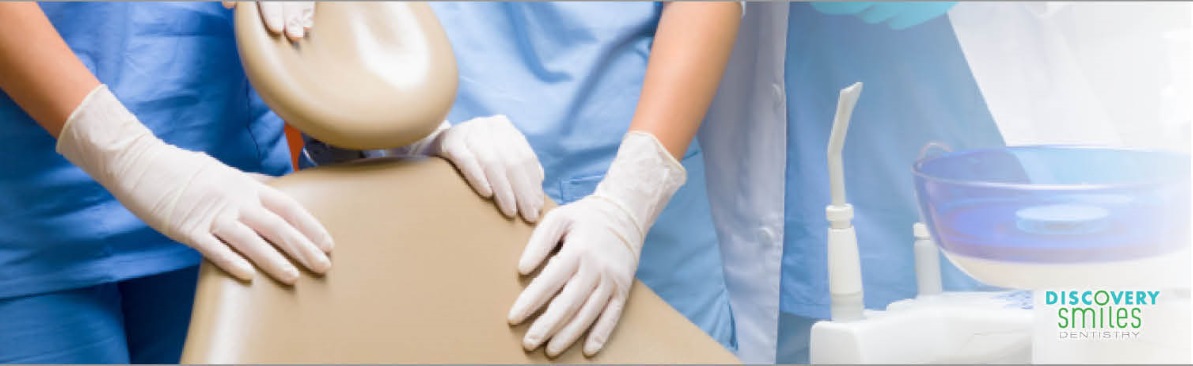 An image of dental technicians behind a dental chair portrays the concept of About Us at Discovery Smiles Dentistry.